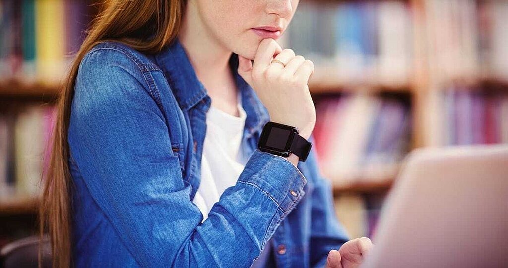 Wearables Schülerin mit Smartwatch am Laptop